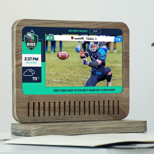 Digital photo frame on wooden desk with slideshow